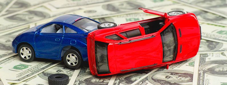 Two toy cars on top of a layer of 100-dollar bills, symbolizing a car accident claim.