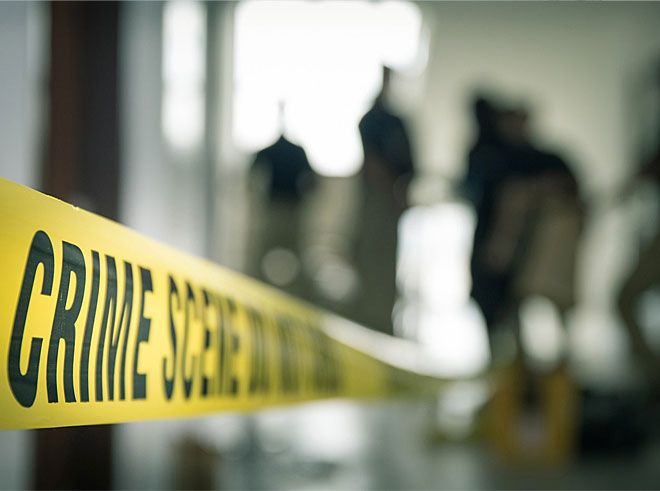 Police tape and blurry figures at a Texas crime scene