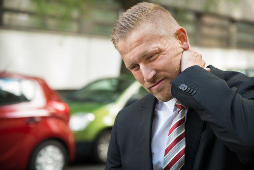 Man grabbing neck in pain