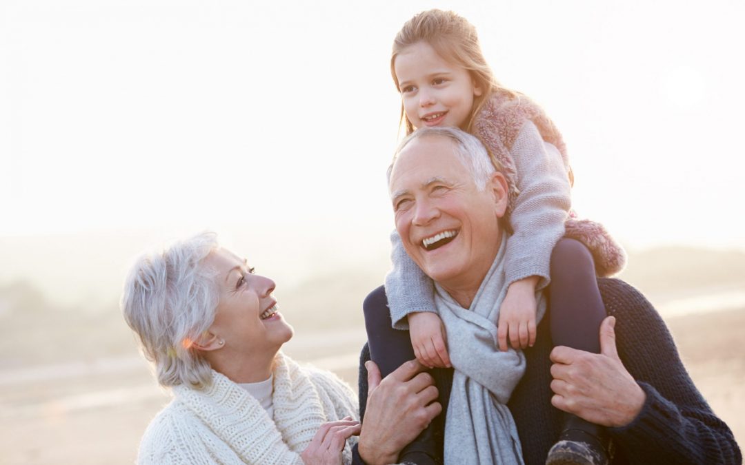 Grandparents with a granddaughter on her grandfather's shoulders